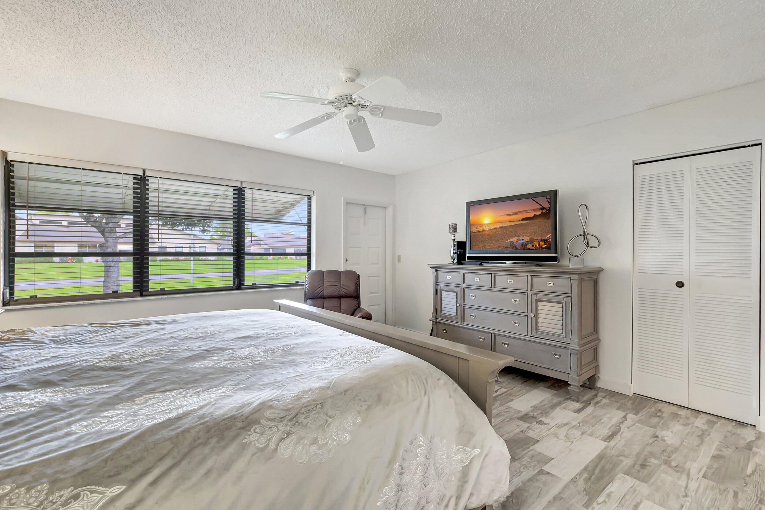 14040 Nesting Way, Unit B Delray Beach, FL 33484 - Photo 20 of 26 a bedroom with a bed and a flat screen tv