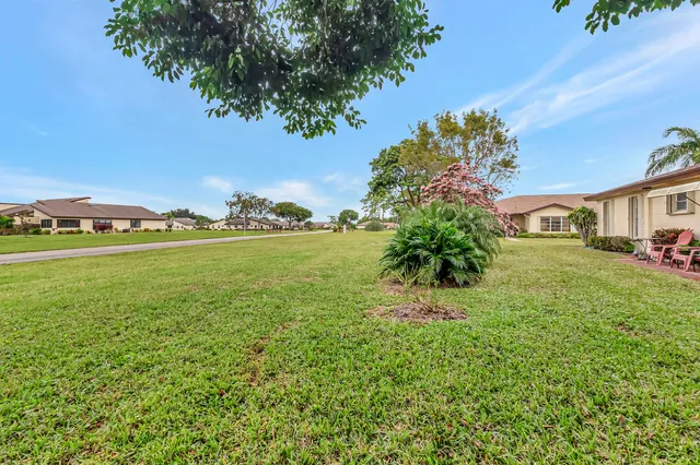 a view of yard with swimming pool and green space