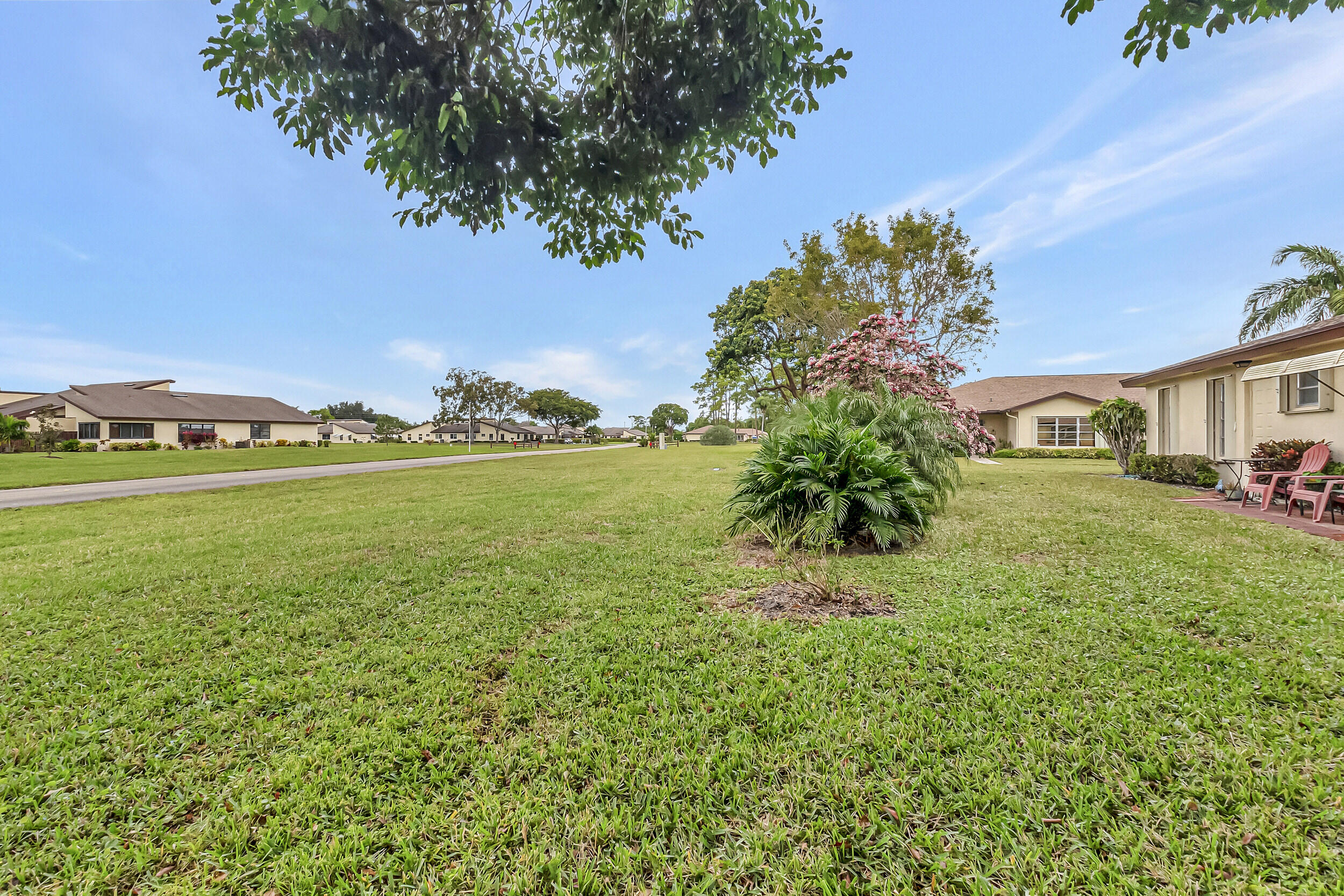 14040 Nesting Way, Unit B Delray Beach, FL 33484 - Photo 26 of 26 a view of yard with swimming pool and green space