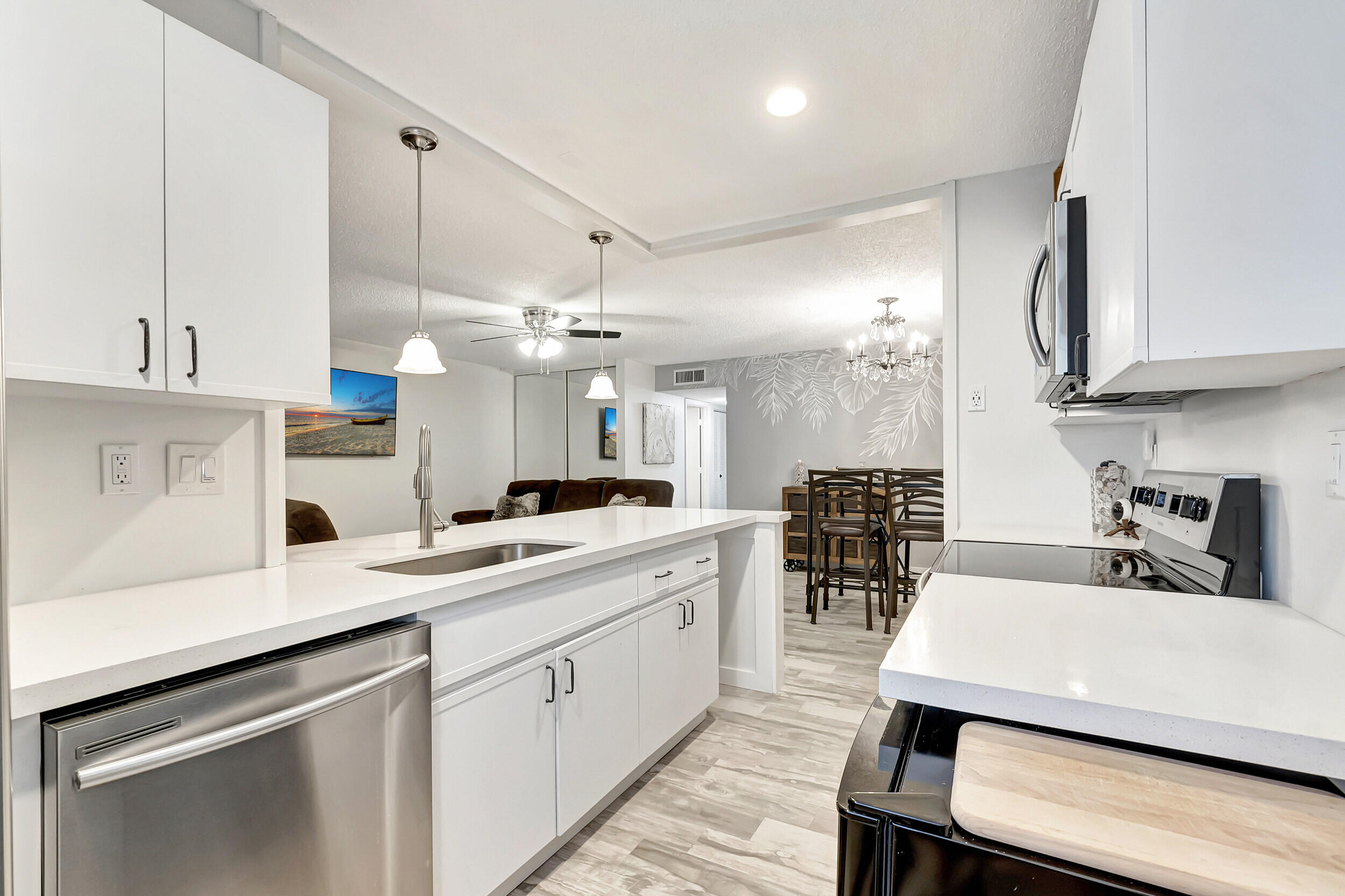 14040 Nesting Way, Unit B Delray Beach, FL 33484 - Photo 8 of 26 a kitchen with a sink a center island stainless steel appliances and cabinets