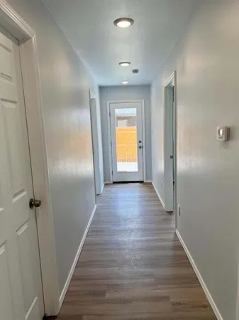 a view of hallway with wooden floor