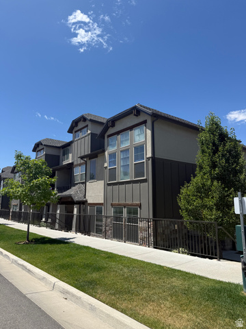10422 South Beetdigger Boulevard Sandy, UT 84070 - Photo 2 of 25 Modern multi-story facade featuring varied siding materials, prominent window arrays, dark trim accents, and a stone-clad base