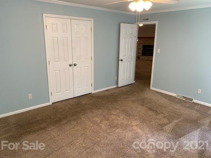 7596 Lowesville Meadows Road Stanley, NC 28164 - Photo 16 of 23 an empty room with closet and windows