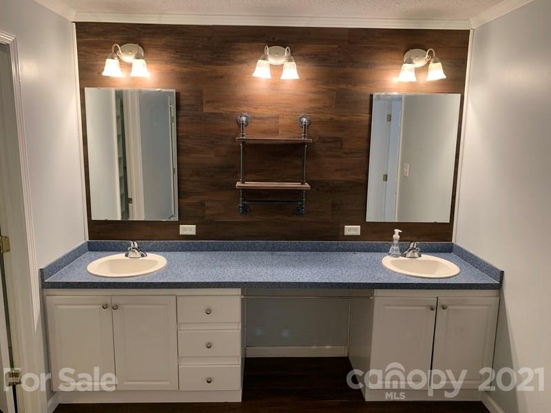 7596 Lowesville Meadows Road Stanley, NC 28164 - Photo 17 of 23 a bathroom with a sink and a mirror