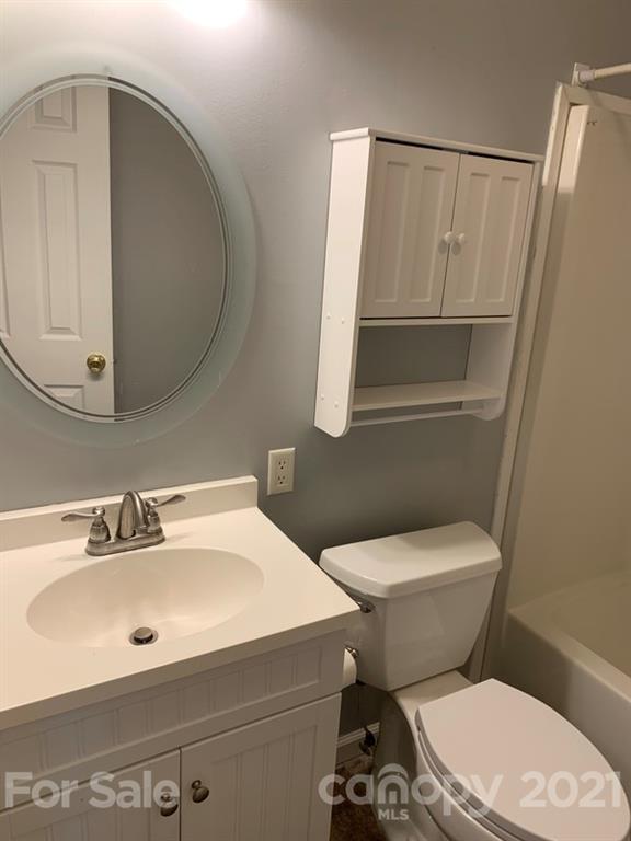 7596 Lowesville Meadows Road Stanley, NC 28164 - Photo 8 of 23 a white toilet sitting next to a bathroom sink