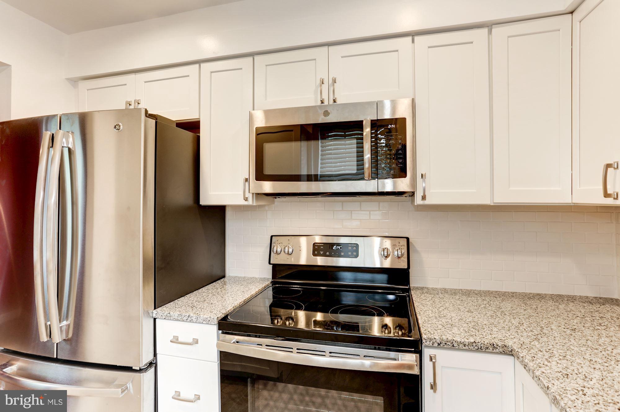 4608 31st Road South, Unit B2 Arlington, VA 22206 - Photo 3 of 29 a kitchen with stainless steel appliances granite countertop a stove and a microwave