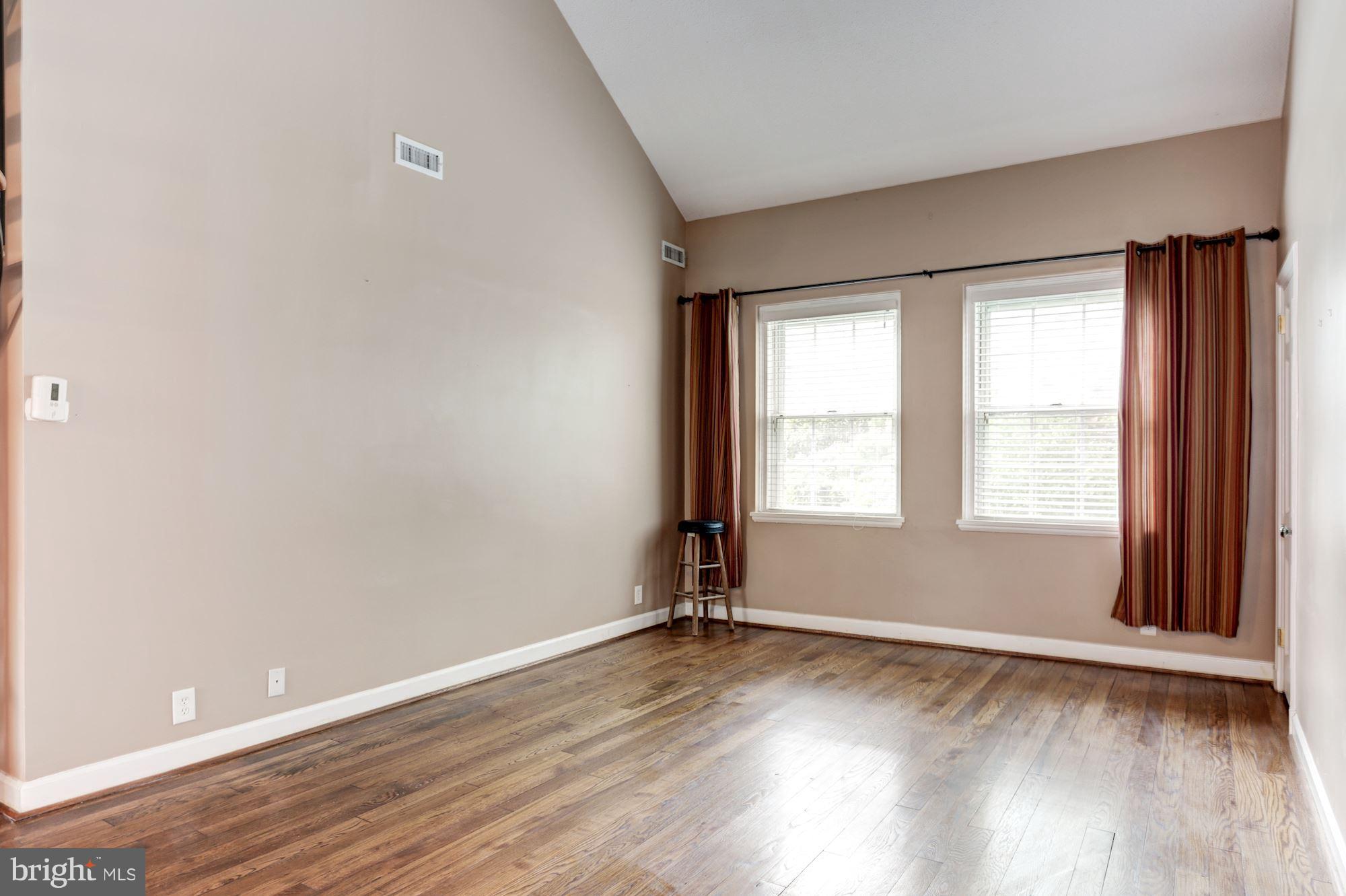 4608 31st Road South, Unit B2 Arlington, VA 22206 - Photo 5 of 29 an empty room with wooden floor and windows