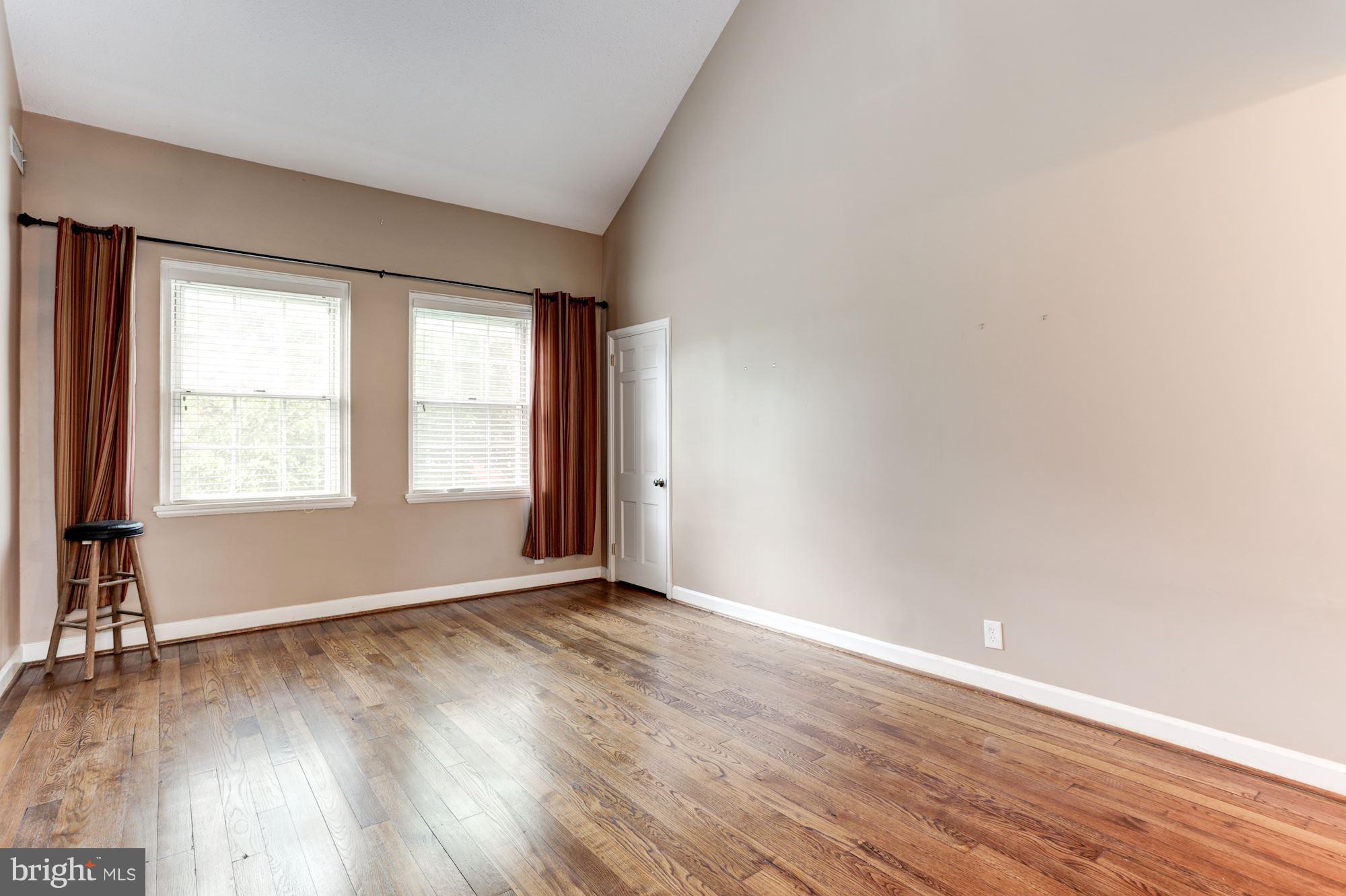 4608 31st Road South, Unit B2 Arlington, VA 22206 - Photo 7 of 29 an empty room with wooden floor and windows