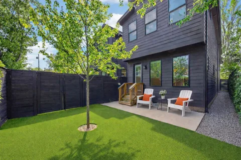 a backyard of a house with table and chairs