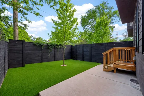 a view of garden with wooden fence
