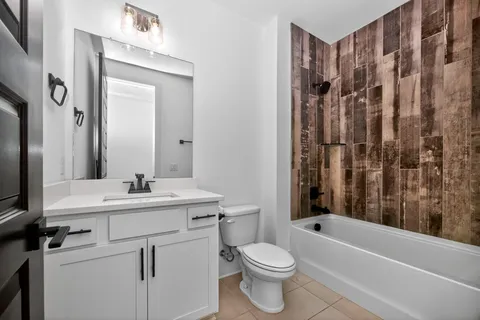 a bathroom with a sink a toilet and a bathtub