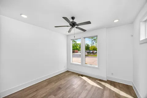 wooden floor in an empty room with a window