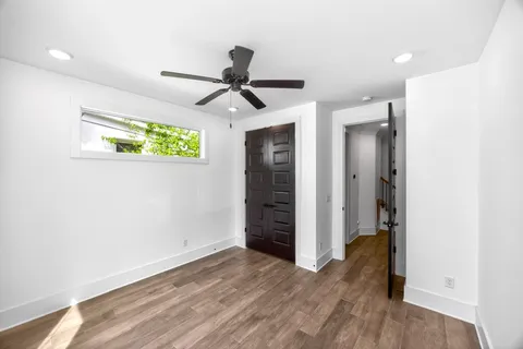 a view of room with wooden floor and ceiling fan