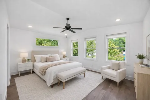 a bedroom with a large bed and a couch