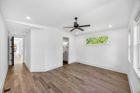 a view of empty room with wooden floor