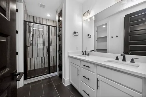 a bathroom with a double vanity sink and mirror