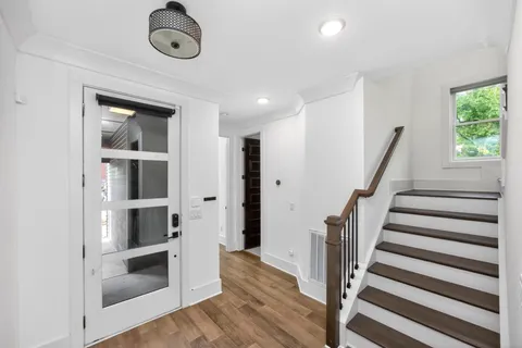 a view of entryway with wooden floor and fan