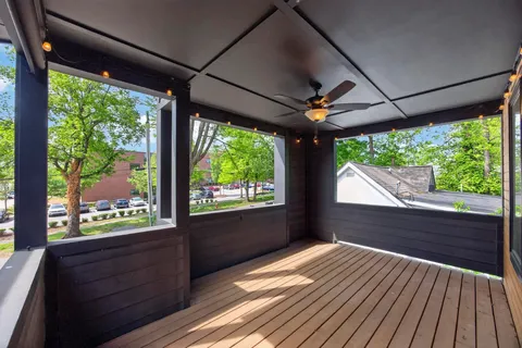 a view of a room with wooden floor and outdoor space