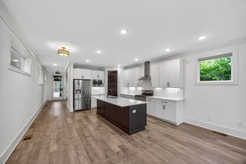 a view of kitchen with wooden floor and electronic appliances