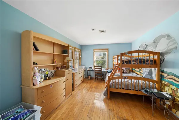 a bedroom with furniture and a wooden floor