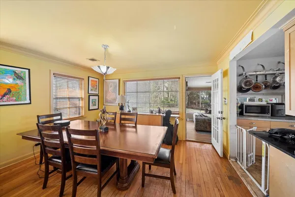 a view of a dining room with furniture and wooden floor