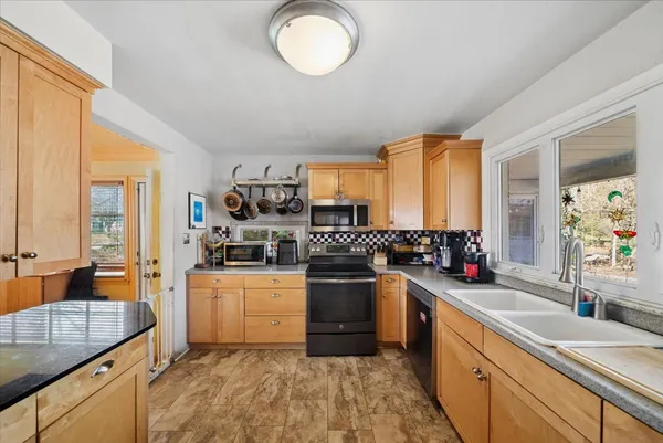 a kitchen with a sink stove and cabinets