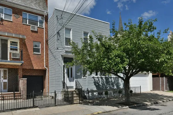 a front view of a house with tree s