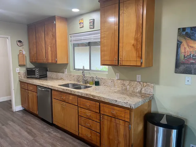 a kitchen with stainless steel appliances granite countertop a sink and a cabinets
