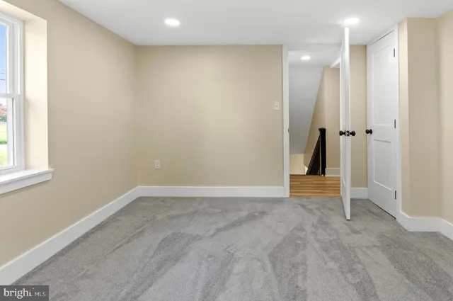 a view of a room with wooden floor and a window