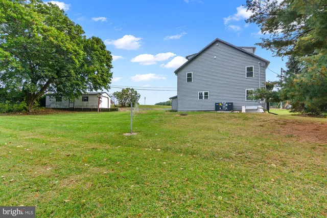 a front view of a house with a yard and fence