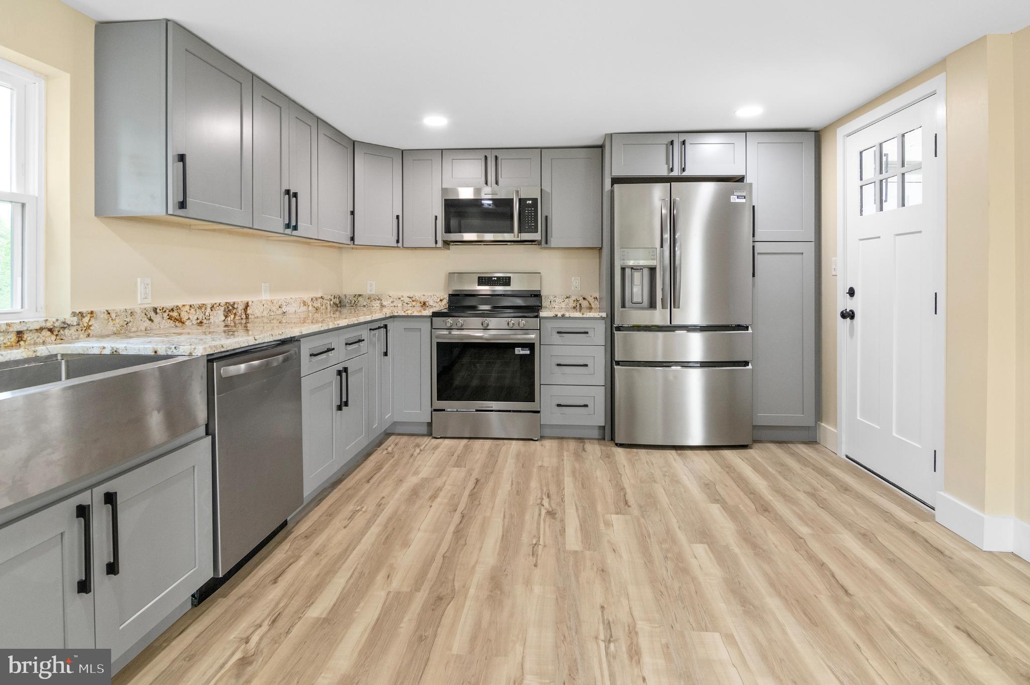 1741 Liberty Grove Road Colora, MD 21917 - Photo 6 of 55 a kitchen with stainless steel appliances granite countertop a refrigerator stove a sink and dishwasher with wooden floor