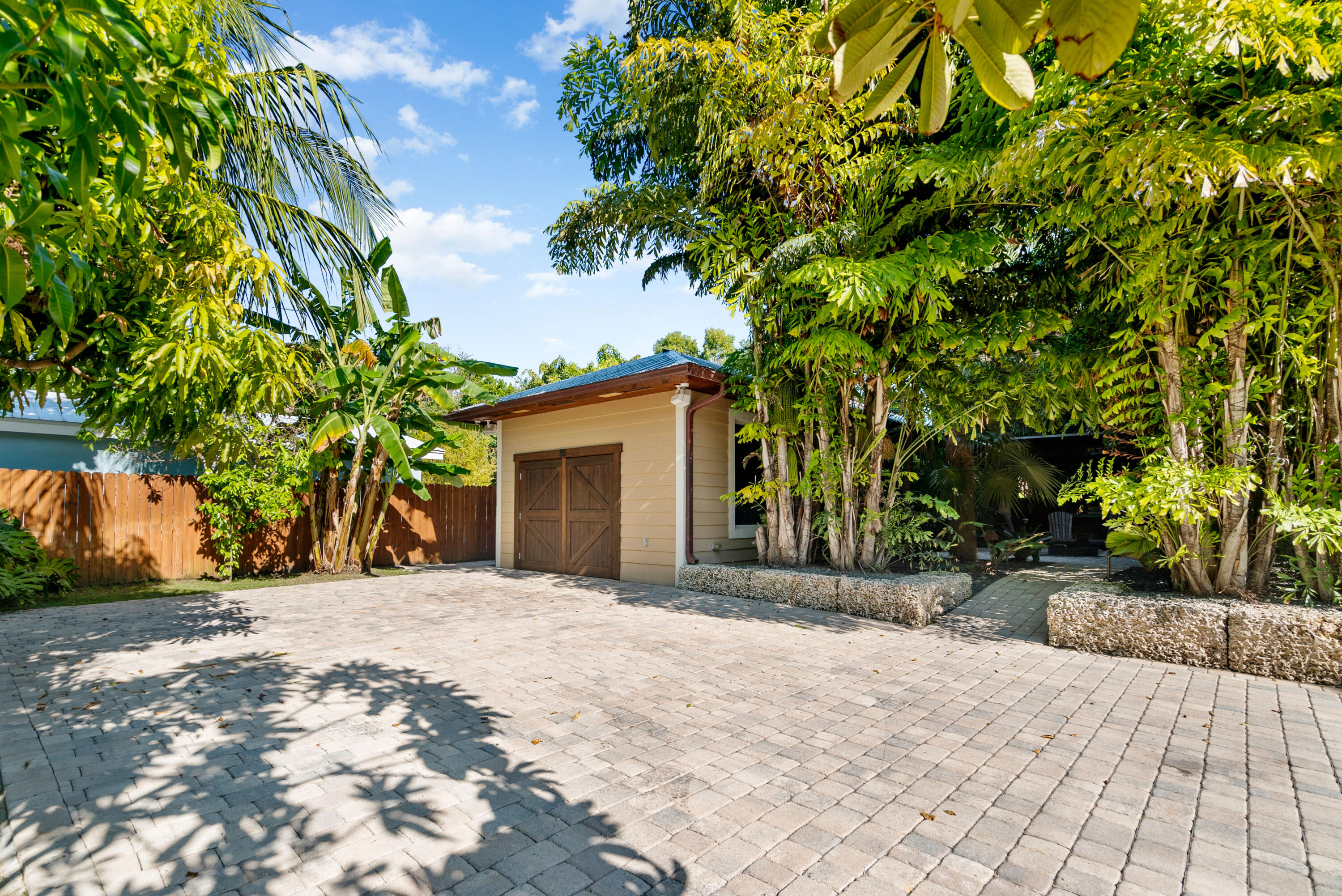 85 Henry Morgan Drive Key Largo, FL 33037 - Photo 2 of 40 a front view of a house with a yard and garage