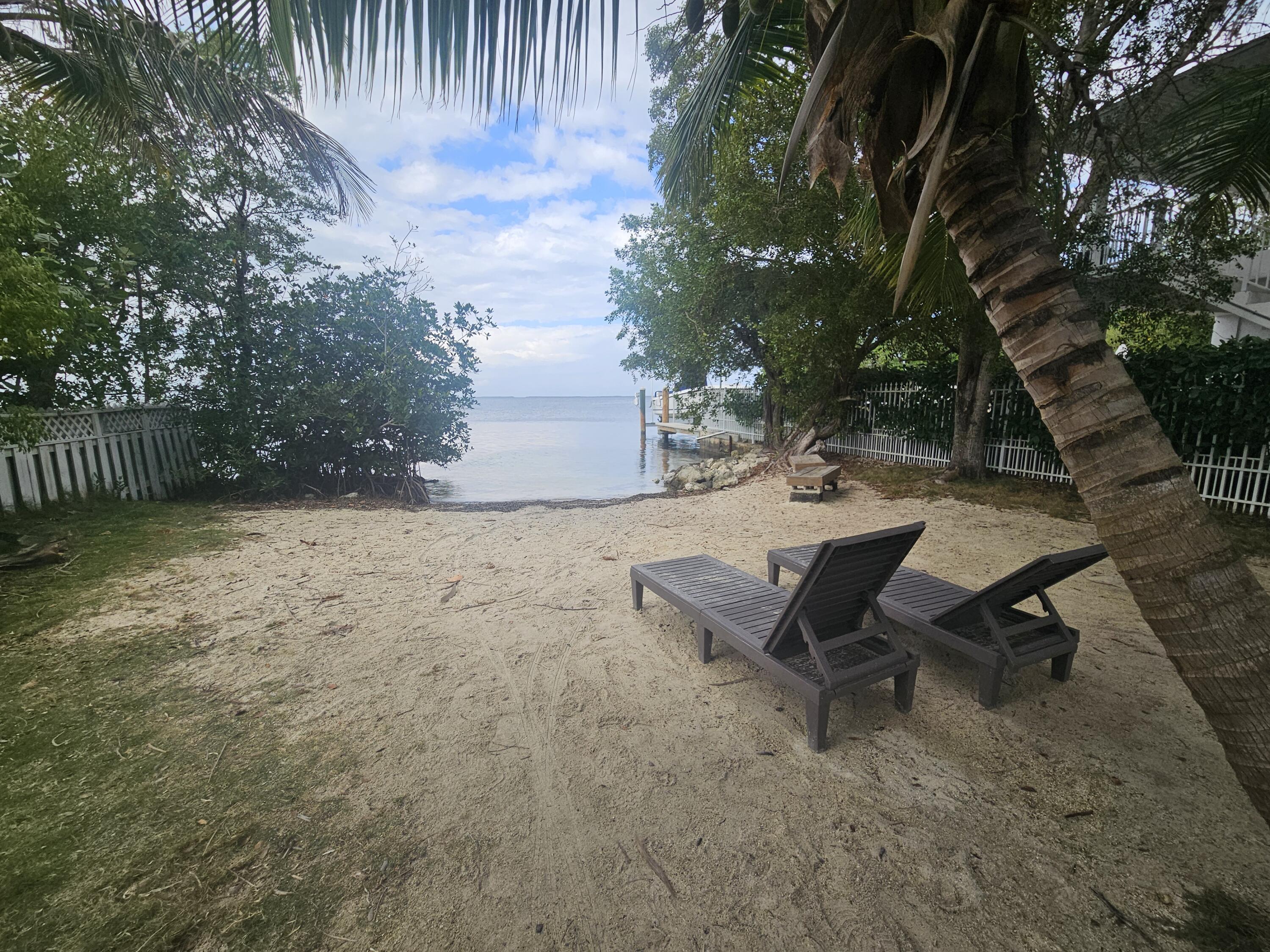 85 Henry Morgan Drive Key Largo, FL 33037 - Photo 32 of 40 a view of a backyard with sitting area