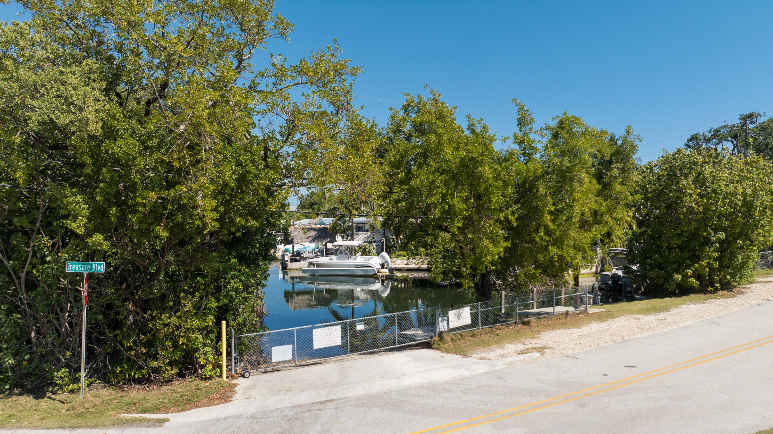 85 Henry Morgan Drive Key Largo, FL 33037 - Photo 35 of 40 a view of a bench next to a yard
