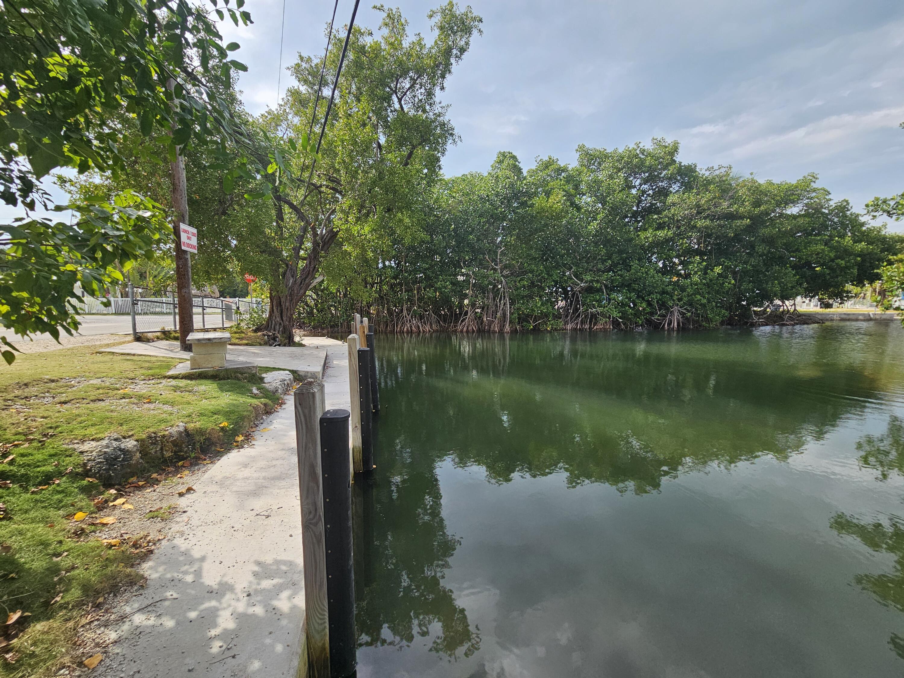 85 Henry Morgan Drive Key Largo, FL 33037 - Photo 36 of 40 a view of a lake with a yard and large trees