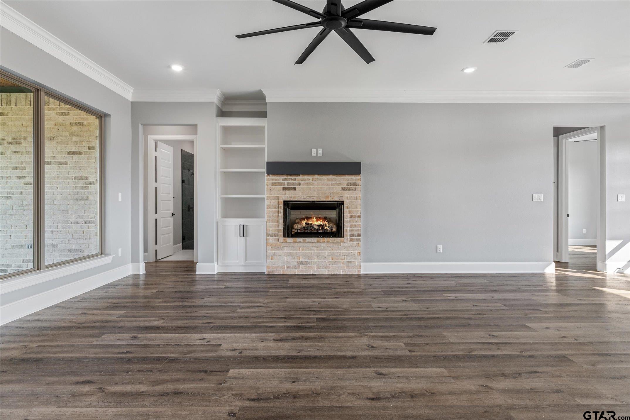 403 Sides Bullard, TX 75757 - Photo 21 of 33 a view of a livingroom with a ceiling fan window and a fireplace