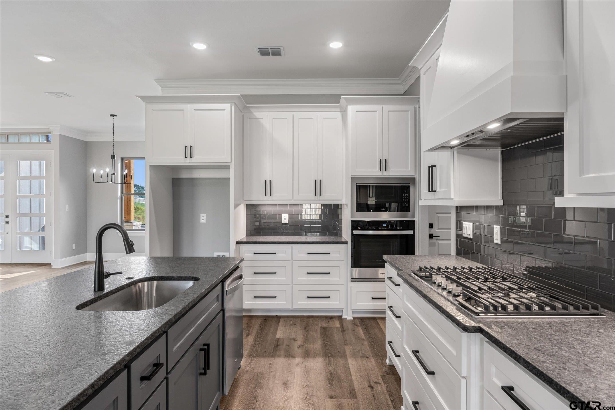 403 Sides Bullard, TX 75757 - Photo 8 of 33 a kitchen with kitchen island a sink stove top oven and cabinets