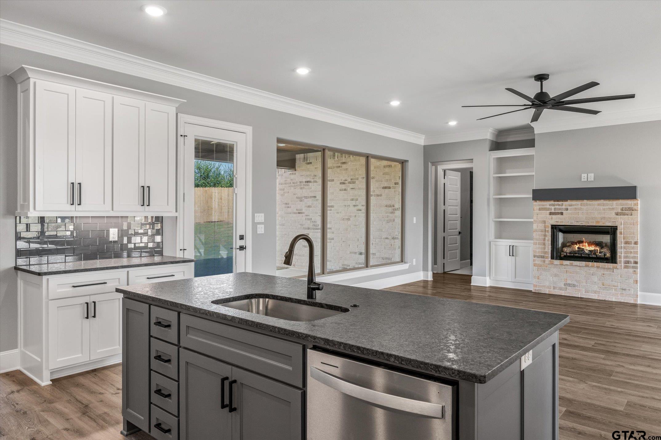 403 Sides Bullard, TX 75757 - Photo 9 of 33 a kitchen with granite countertop a sink stainless steel appliances and window