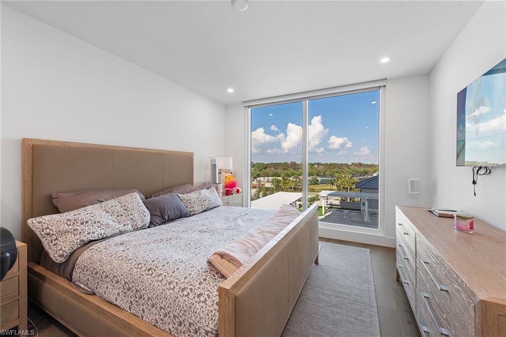 13945 Old Coast Road, Unit 406 Naples, FL 34110 - Photo 16 of 46 a living room with furniture and a large window