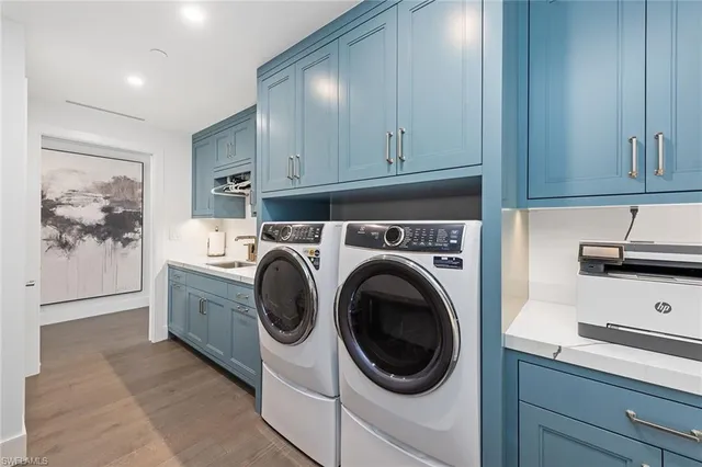 a utility room with sink dryer and washer