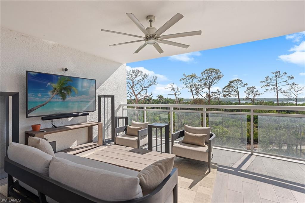 13945 Old Coast Road, Unit 406 Naples, FL 34110 - Photo 23 of 46 a living room with furniture and a flat screen tv