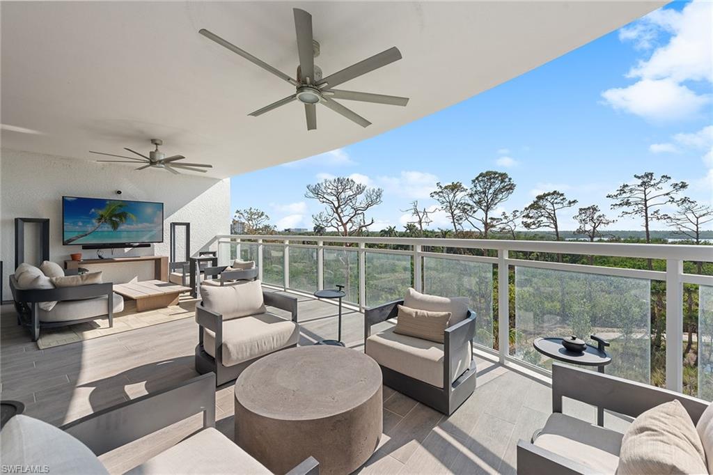 13945 Old Coast Road, Unit 406 Naples, FL 34110 - Photo 24 of 46 a living room with furniture and a large window
