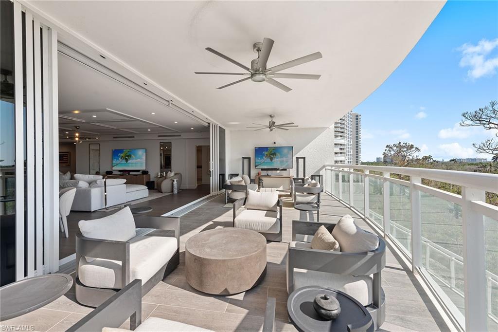 13945 Old Coast Road, Unit 406 Naples, FL 34110 - Photo 25 of 46 a living room with furniture and a large window