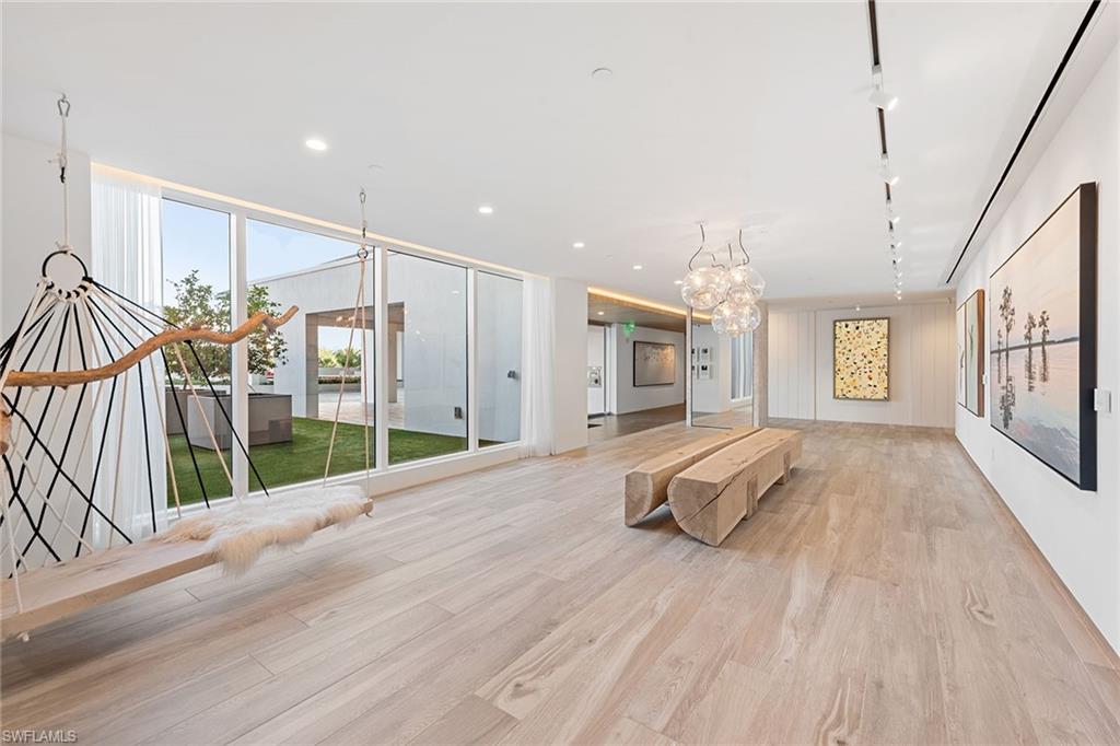 13945 Old Coast Road, Unit 406 Naples, FL 34110 - Photo 26 of 46 a view of hallway with wooden floor and windows