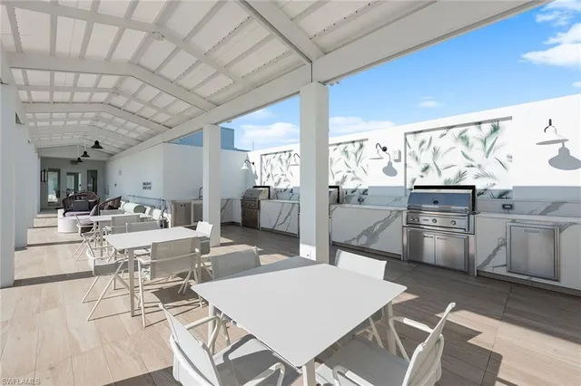 a large kitchen with a table and chairs