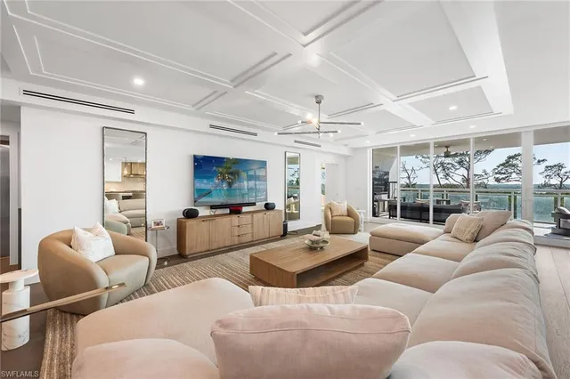 a living room with furniture a rug and a large window