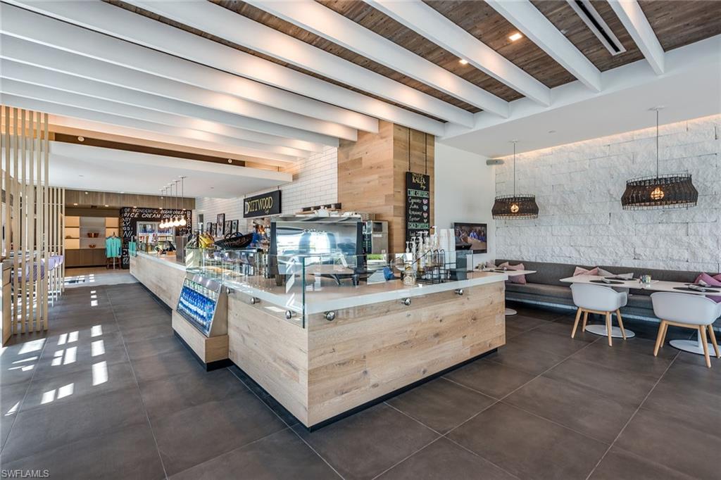 13945 Old Coast Road, Unit 406 Naples, FL 34110 - Photo 42 of 46 a kitchen with stainless steel appliances kitchen island granite countertop lots of counter top space