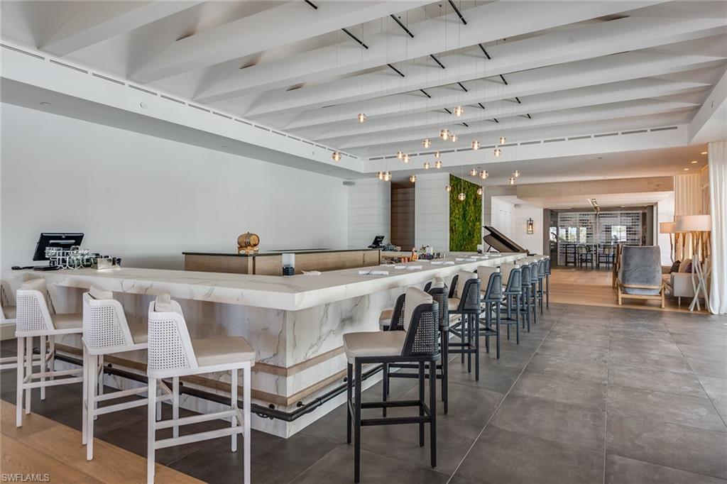 13945 Old Coast Road, Unit 406 Naples, FL 34110 - Photo 43 of 46 a view of a dining room with furniture