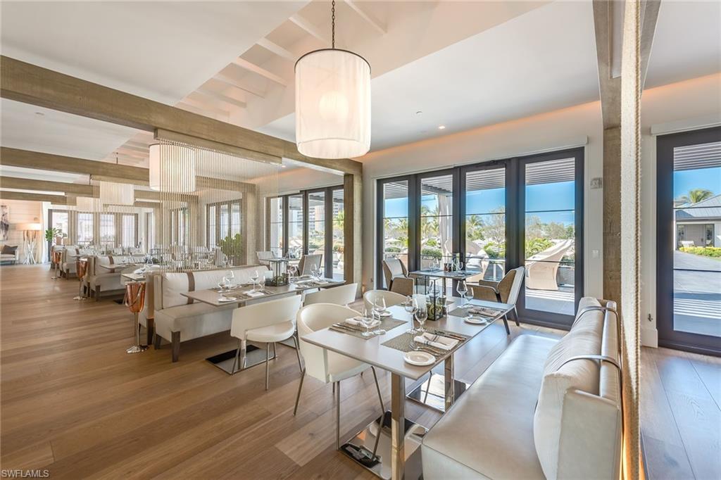 13945 Old Coast Road, Unit 406 Naples, FL 34110 - Photo 44 of 46 a view of a dining room with furniture window and wooden floor