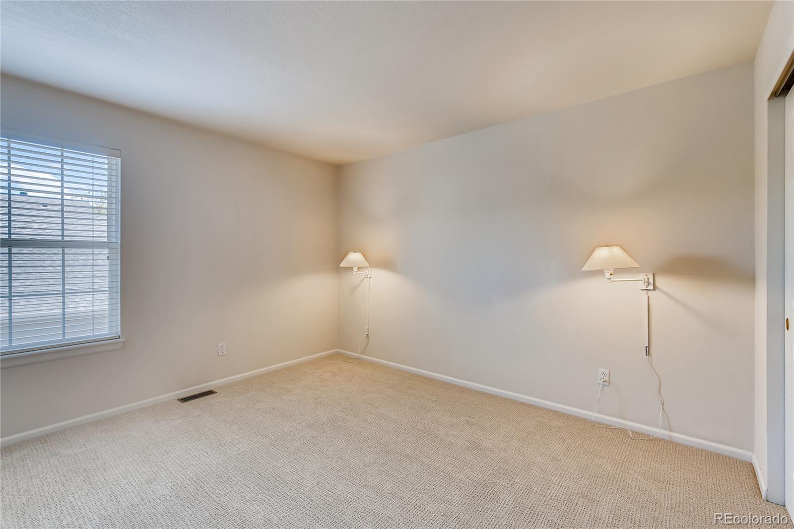 6137 Trailhead Road Highlands Ranch, CO 80130 - Photo 14 of 27 wooden floor in an empty room with a window